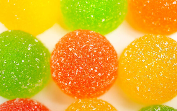 colored marmelades on white background