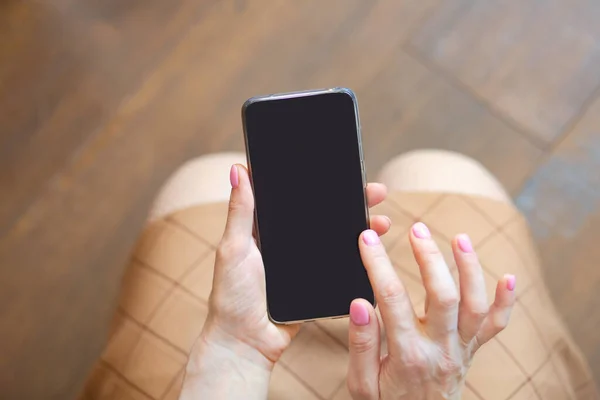 closeup view of smartphone with black screen in woman hands, copy space concept background
