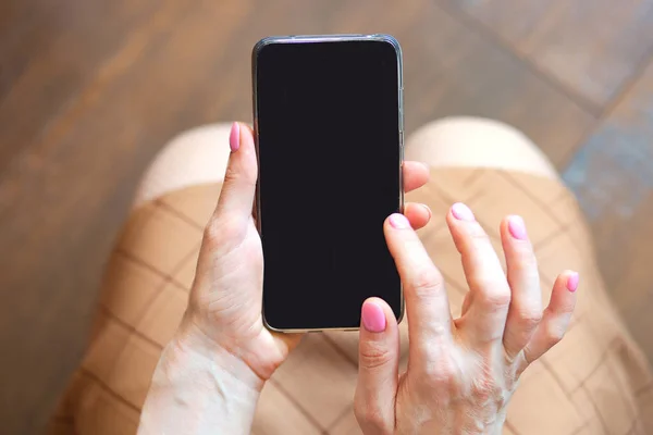 closeup view of smartphone with black screen in woman hands, copy space concept background