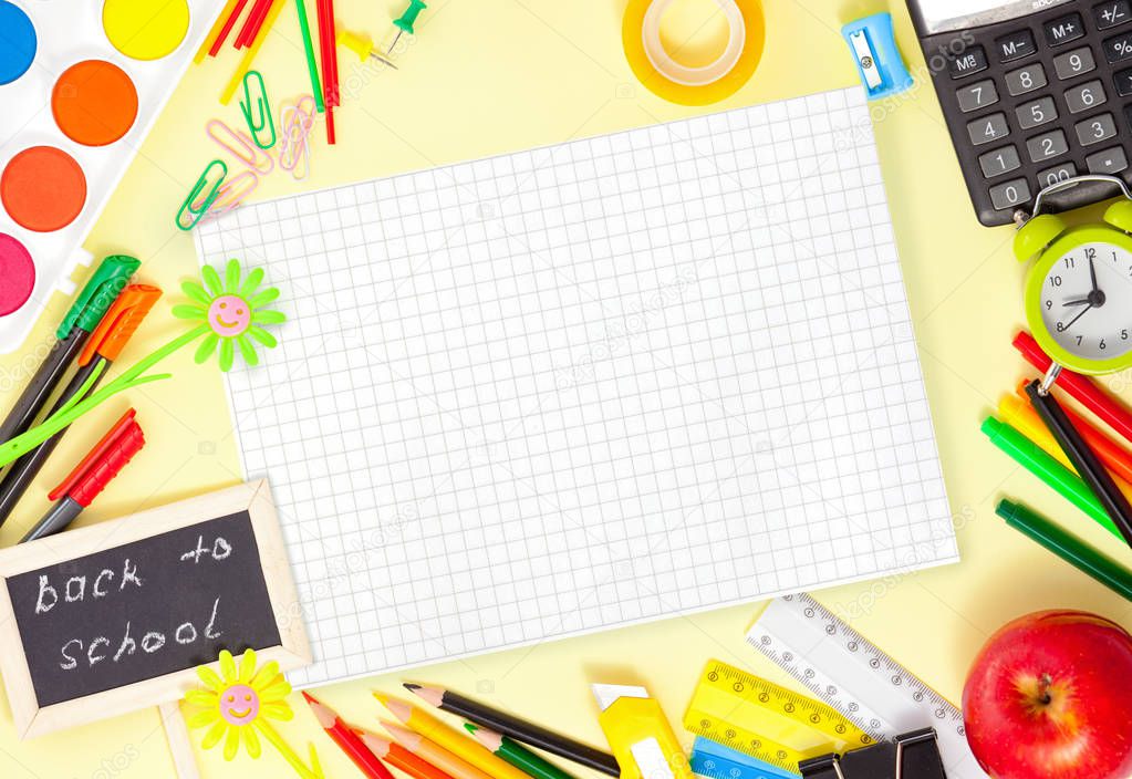 Back to School Conceptl: Colorful Felt Pens and Pancils, Red Applem, Alarm Clock, Sheet of Paper, Yellow and Green Daisy and Little Blackboard on the Yellow Background