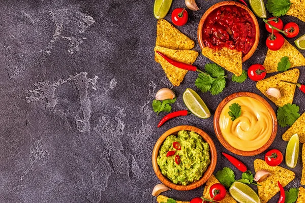 Mexican food background: guacamole, salsa, cheesy sauces