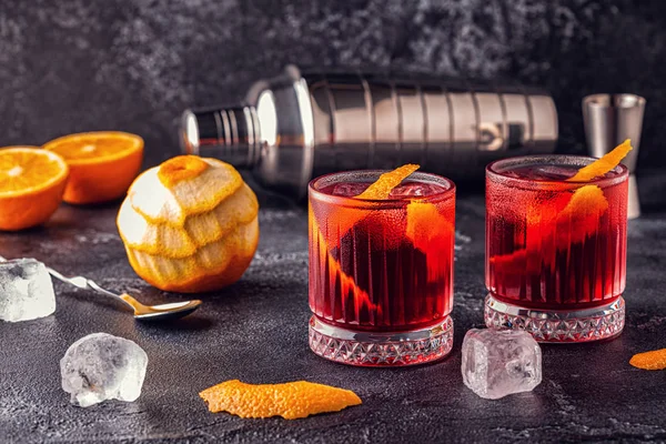 Negroni cocktail with orange peel and ice.