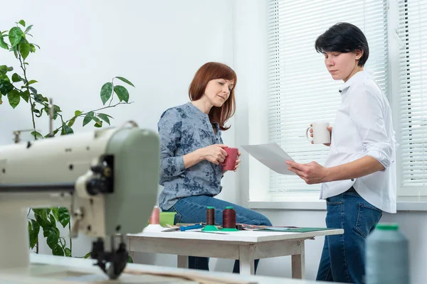 workers at lunch break drink coffee tea and discuss problems