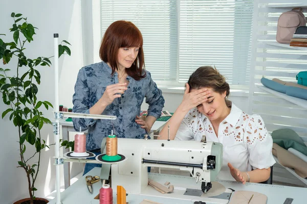 Mentor Teaches Student Sew Royalty Free Stock Images