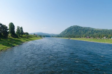 Güneşli bir günde hızlı bir dağ nehri. Köprüden görüntüle