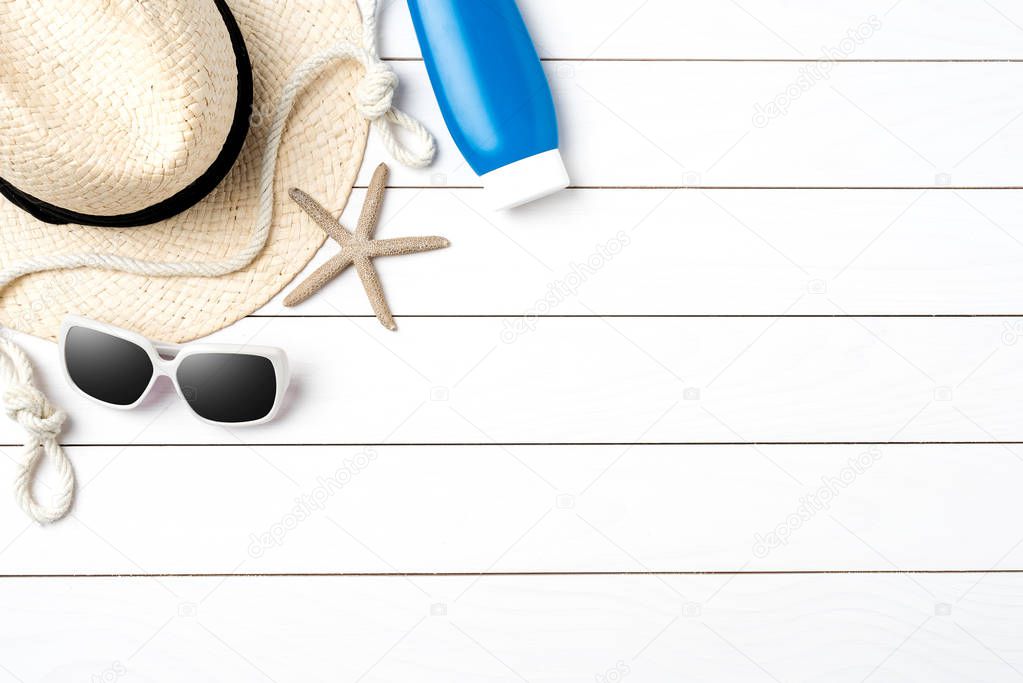 Beach accessories on white wooden table. Summer background