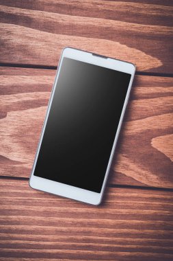 Ahşap arka plan smartphone. Üstten Görünüm