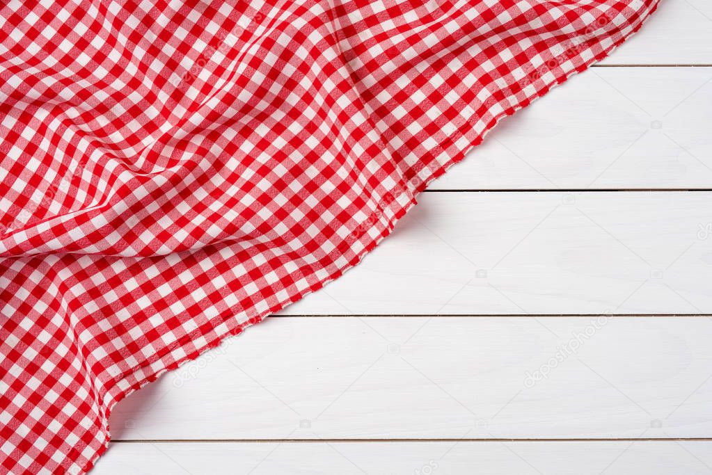 Red checkered tablecloth over white wooden table