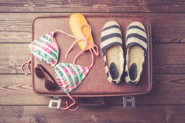 Bavul yazlık giysiler ve aksesuarlar ile. Üstten görünüm