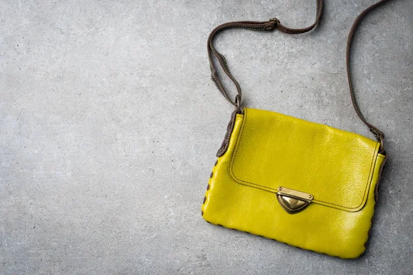 Overhead shot of casual yellow female handbag