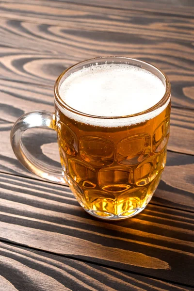 Mug of beer on an old wooden table