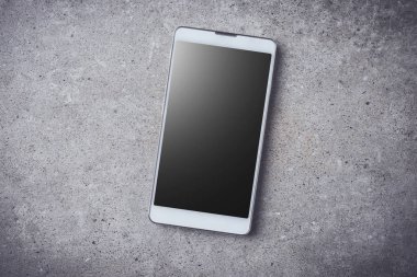 Gri taş zemin üzerine akıllı telefon