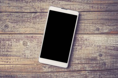 Eski bir ahşap zemin üzerine modern akıllı telefon