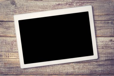 Eski bir ahşap zemin üzerine modern dijital tablet