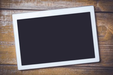 Modern dijital tablet eski bir ahşap arka plan üzerinde. Yakın çekim