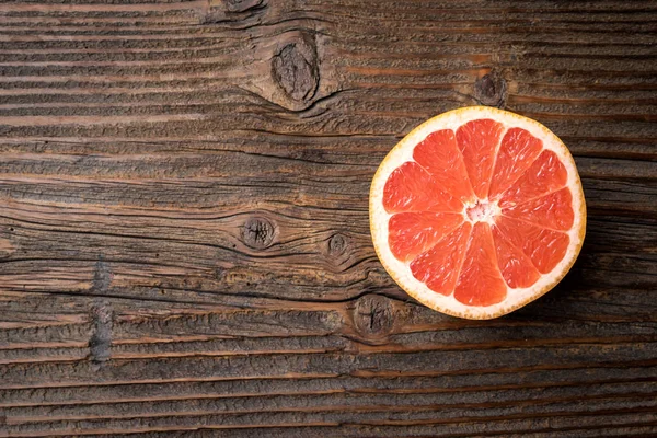 Red grapefruits on an old wooden table