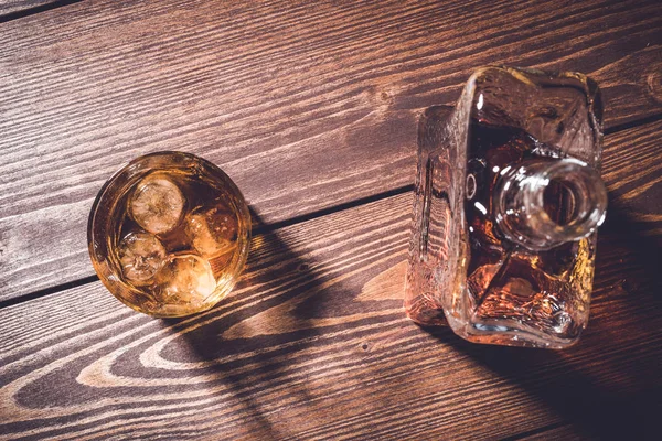 古い木製のテーブルでウィスキー グラスにウイスキーのボトル — ストック写真