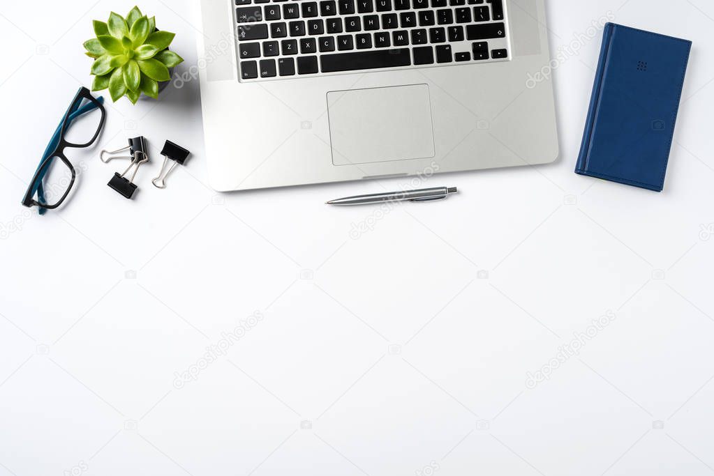 Overhead shot of office accessories on white background