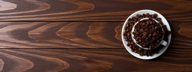 İçinde beyaz kahve fincanı kavrulmuş kahve çekirdekleri. Yakın çekim