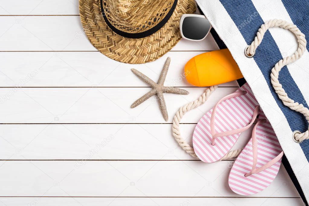 Beach accessories on white wooden table. Summer background with copy space