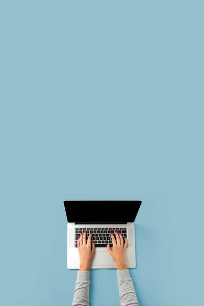 Woman working on laptop. Top view