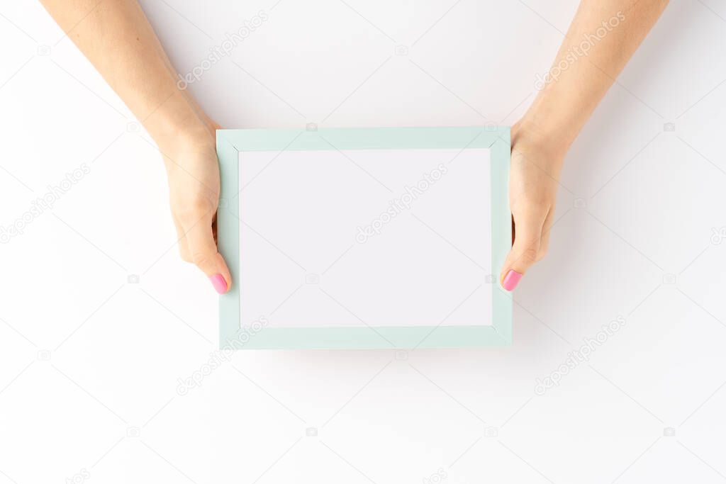 Woman hands showing blank photo frame isolated on white background. Mockup