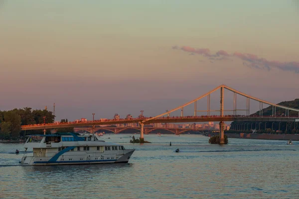 Pedestrian Bridge over Dnieper river at sunset in Kyiv, Ukraine