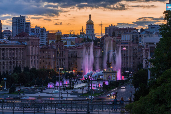 Kyiv / Ukraine - August 13 2020: Maidan Nezalezhnosti, the main square of  the Kyiv city at sunset.  The colorful fountains are in the center of the square.