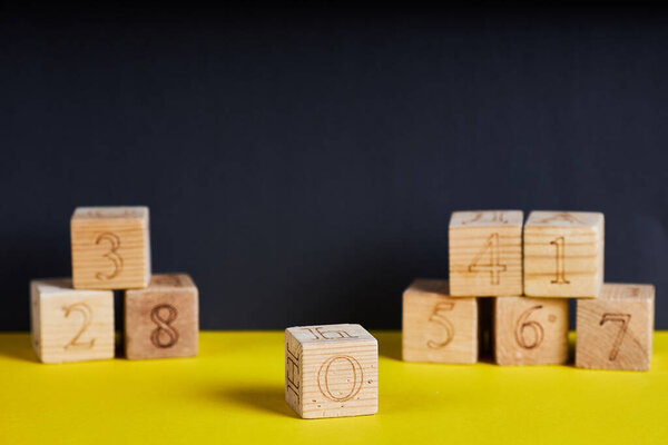 Numbers on wooden cubes. The number zero is in forward.