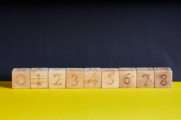 Numbers on wooden cubes in line