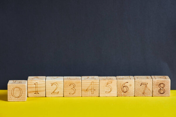 Numbers on wooden cubes in line . The number zero is in forward.