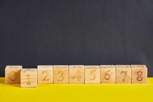 Numbers on wooden cubes in line . The number one is in forward.