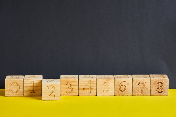 Numbers on wooden cubes in line . The number two is in forward.