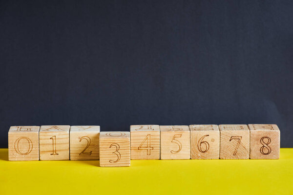 Numbers on wooden cubes in line . The number three is in forward.