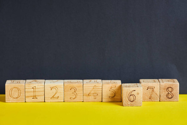Numbers on wooden cubes in line . The number six is in forward.