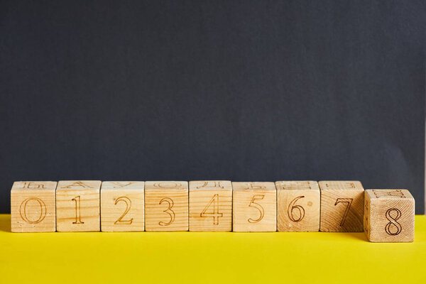 Numbers on wooden cubes in line . The number eight is in forward.