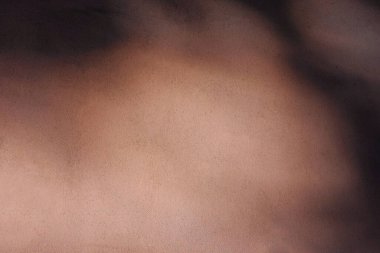 Eski bir evin duvarının desenli beton yüzeyine sahip arka planda bir chiaroscuro oyunu ve eşit olmayan doğal ışık lekeleri var. Tasarım için kullanılabilir. 