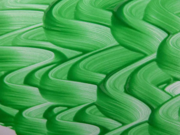 Hullámos vonalak zöld festékkel — Stock Fotó