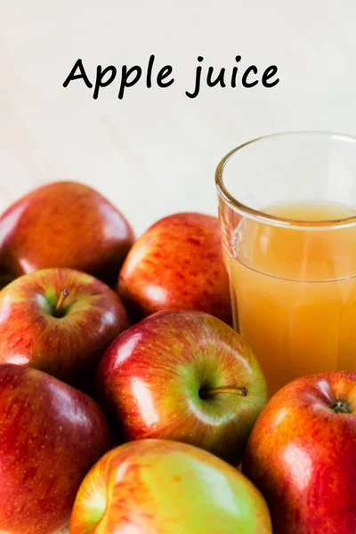 Glass of fresh apple juice near autumn apples. Wooden background, top view, text apple juice.