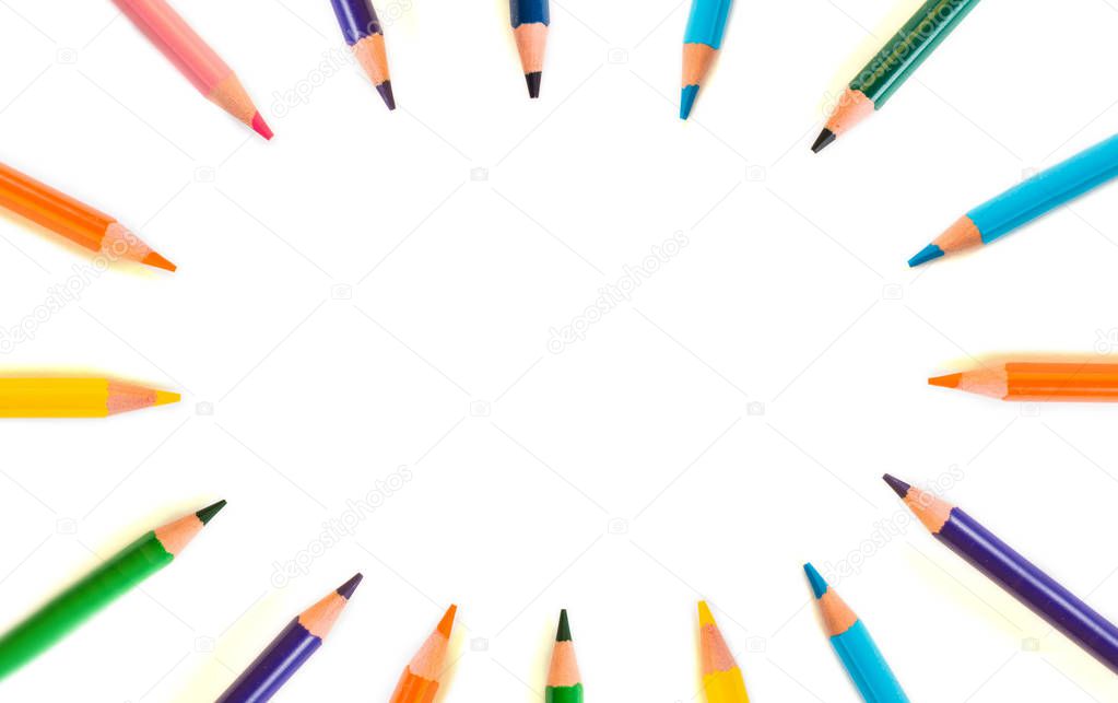 Color pencils in circle isolated on white background. Close up. View from above.
