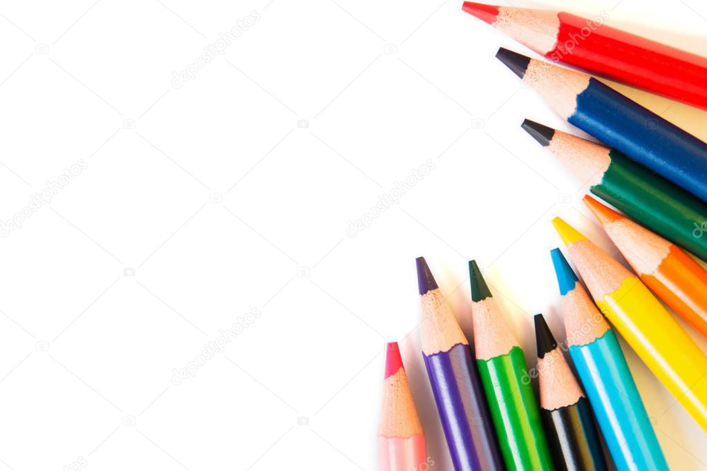 Color pencils in circle isolated on white background. Close up. View from above.