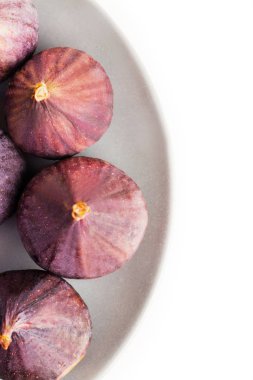 Beyaz arka plan üzerinde izole gri plaka üzerinde taze incir. Yukarıdan görüntüleyin. Metin için yer kopyalayın