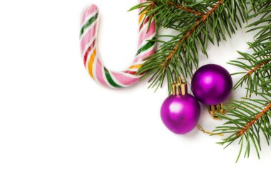 Noel ve yeni yıl gün festival dekorasyon, iki mor top, renkli şekerler ve beyaz arka plan üzerinde izole köknar ağacı. Metin için yer kopyalayın. Yukarıdan görüntülemek.