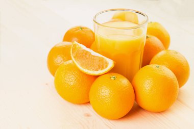 Bardak taze portakal suyu ile portakal preslenmiş ve turuncu ahşap arka plan üzerine dilimlenmiş. Sağlıklı yaşam konsepti. Metin için yer kopyalayın.