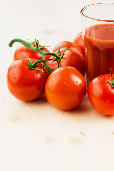 Glass of tomato juice with tomatoes on wooden background, Healthy lifestyle concept. Copy space for text.