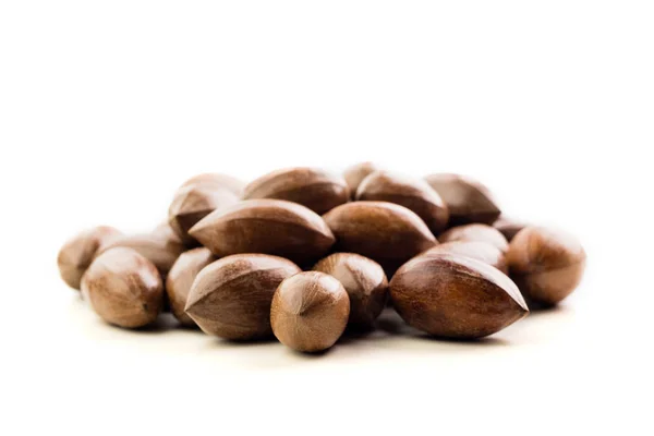 Not cleaned pecan nuts in the shell isolated on white. — Stock Photo, Image