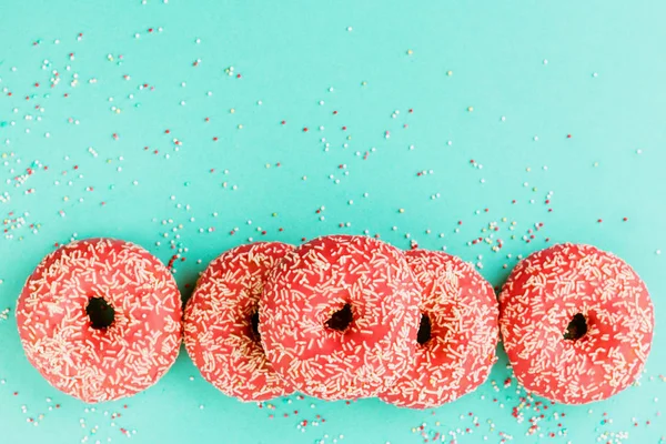 Donuts decorados com gelo sobre fundo azul . — Fotografia de Stock