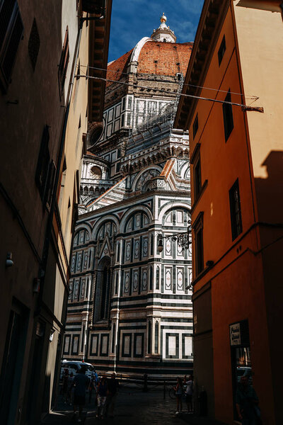 The famous Basilica Church of Santa Maria del Fiore view from a narrow street | FLORENCE, ITALY - 14 SEPTEMBER 2018.