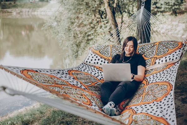 Девушка Работает Ноутбуке Лежит Гамаке Солнечном Летнем Парке — стоковое фото