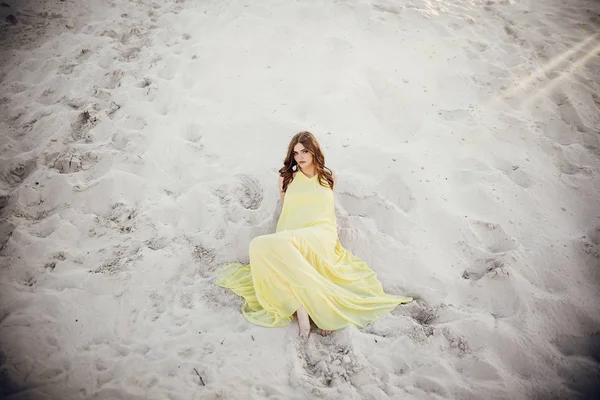 Beautiful Girl Yellow Dress Windy Hair Lying Sandy Beach Full — Stock Photo, Image